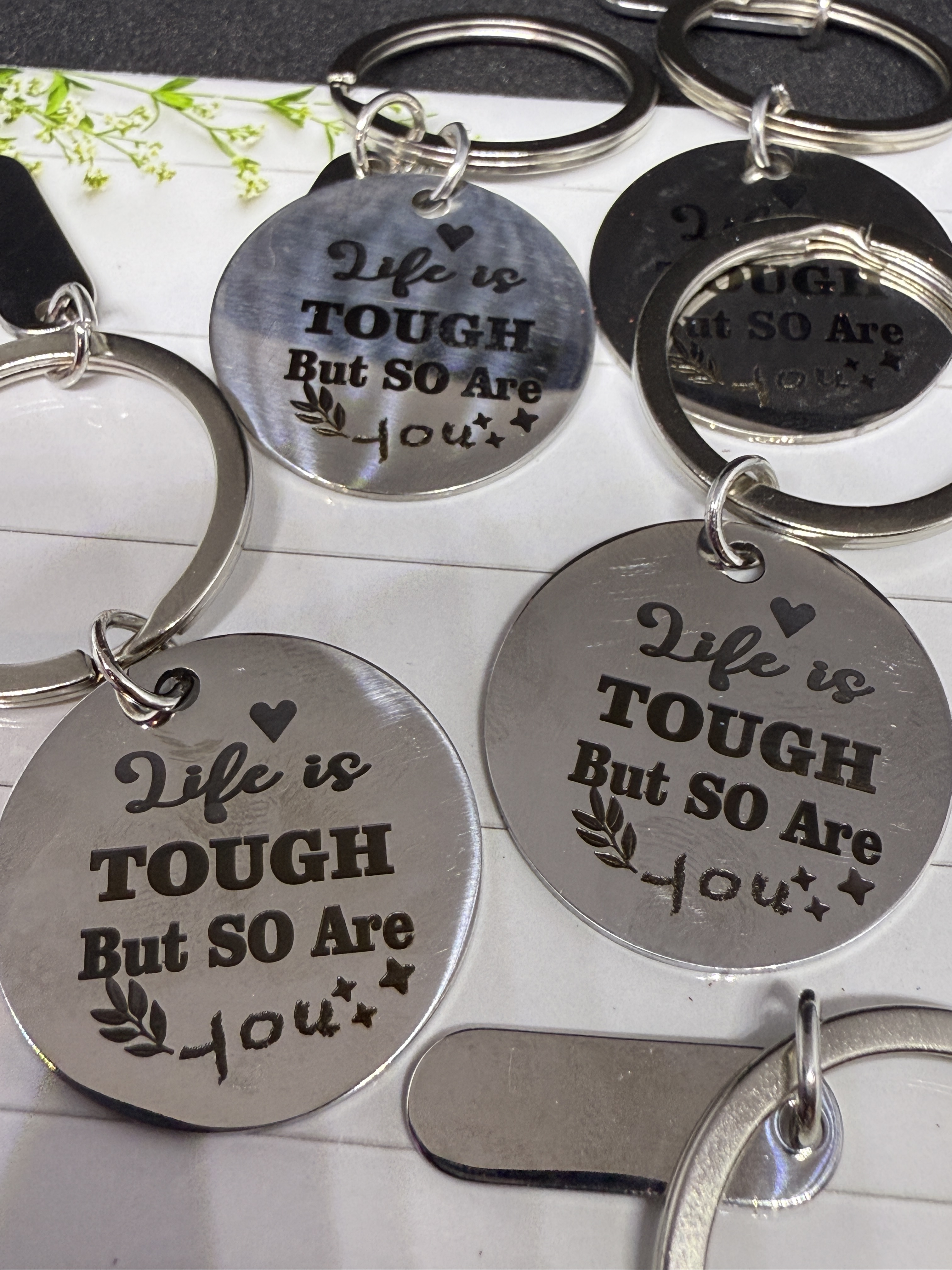 An antique gold locket rests on a reflective, ornate wooden display. The locket consists of two metal hinged disks that co...